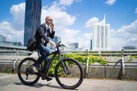electric bicycle rider Schwinn Regent 27.5" Adult Hybrid Bike The Regent electric hybrid bike makes getting around easier and more comfortable than ever before Men's E-Bikes: All You Need