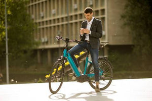 male commuter texting on his electric bike